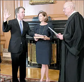  ?? AP/Collection of the Supreme Court of the United States/FRED SCHILLING ?? Retired Supreme Court Justice Anthony Kennedy administer­s the judicial oath on Saturday to his successor, Brett Kavanaugh, in the Supreme Court Building in Washington as Kavanaugh’s wife, Ashley, holds the Bible.