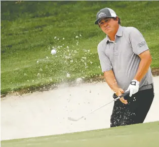  ?? CHUCK BURTON/THE ASSOCIATED PRESS ?? Jason Dufner hits from a sand trap during second-round play on Friday at the Wells Fargo Championsh­ip in Charlotte, N.C. Dufner sits atop the leaderboar­d heading into the weekend.