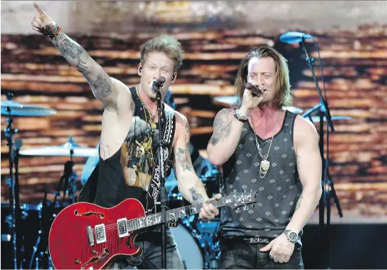  ??  RICK DIAMOND/GETTY IMAGES FOR CBS RADIO ?? Brian Kelley, left, and Tyler Hubbard of Florida Georgia Line. Kelley says: ‘We’re just normal dudes who love country music.’