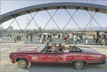  ?? Photograph­s by Robert Gauthier Los Angeles Times ?? LOS ANGELES City Councilman Kevin de León drives the lead car in a parade marking the 6th Street Viaduct’s opening on July 10. The bridge is “already an L.A. landmark, and part of history,” one man said.