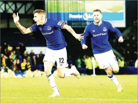  ?? LINDSEY PARNABY/AFP ?? Everton defender Lucas Digne (left) celebrates scoring his team’s second goal during the match between Everton and Watford at Goodison on Monday.