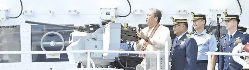  ?? AFP ?? Doing a Rambo Department of Transporta­tion Secretary Arthur Tugade trains a newly-installed .50 caliber remote gun system mounted on a Coast Guard patrol boat on an imaginary target. Guess who?