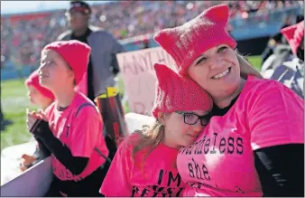  ?? [JOHN LOCHER/THE ASSOCIATED PRESS] ?? Eight-year-old Zoe Rodis leans on her mother, Jennifer Rodis, during a Women’s March rally on Sunday in Las Vegas.