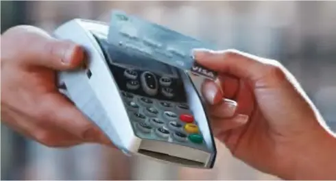  ??  ?? A point of sale terminal and card for electronic payment