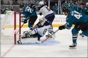  ?? ?? The San Jose Sharks’ Tomas Hertl (48) scores a goal against the Winnipeg Jets’ Connor Hellebuyck (37) in the third period at the SAP Center in San Jose on Saturday.