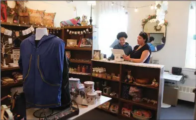  ?? ?? FAMILY BUSINESS—Alice Bioff gets help from her daughter Aries behind the counter at Naataq Gear.