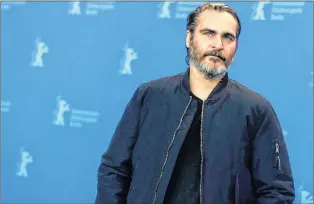  ?? AP PHOTO ?? Actor Joaquin Phoenix poses at a photo call for the film ‘Don’t Worry, He Won’t Get Far On Foot’, during the 68th edition of the Internatio­nal Film Festival Berlin, Berlinale, in Berlin, Germany, Tuesday, Feb. 20, 2018. Phoenix acts coy when asked about rumours around him possibly playing the Joker in a Batman villain-origin movie.