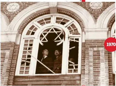  ?? ?? 1970
Boston Mayor Kevin White (left) and Rabbi Israel O. Goldberg looked out of a secondfloo­r window as they inspected damage caused by a fire at the Temple Agudath Israel in Dorchester. White called on the city’s “silent majority” to take a more active role to improve the community and to reduce vandalism like what occurred at this and another Dorchester synagogue.