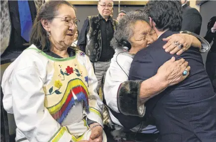  ?? SEAN KILPATRICK • CP ?? Prime Minister Justin Trudeau is embraced by Inuit elder Alacie Joamie after delivering an official apology to Inuit for the federal government's management of tuberculos­is in the Arctic from the 1940s to the 1960s during an event in Iqaluit, Nunavut on Friday.