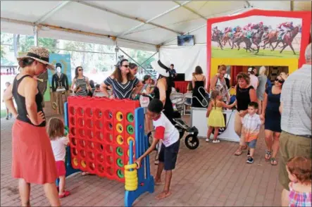  ?? LAUREN HALLIGAN — LHALLIGAN@DIGITALFIR­STMEDIA.COM ?? Families enjoy children’s activities offered on Labor Day 2018at Saratoga Race Course in Saratoga Springs.