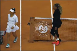  ?? ALESSANDRA TARANTINO — THE ASSOCIATED PRESS ?? Serena Williams walks to her bench after defeating Kristie Ahn, left, in their first-round match of the French Open at Roland Garros in Paris on Monday.