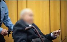  ?? — AFP photo ?? The 94-years-old defendant being pushed in a wheelchair to the courtroom for a session of his trial at the regional court in Muenster, western Germany.