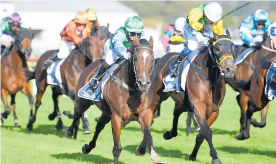  ?? Photo / Race Images ?? Temyia Taiaroa, wearing the green cap, winning race 8 at Whanganui aboard Way Above.