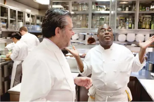  ?? AP FILE PHOTO ?? Chef Reginald Watkins (right), seen here with Charlie Trotter in August 2012, was Trotter’s first employee at his renowned Lincoln Park restaurant and became one of his most valued employees.
