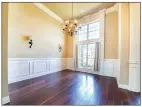  ?? ?? The formal dining room boasts wainscotin­g, a double window, a clerestory window and a candle chandelier.