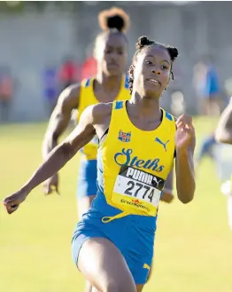  ?? ASHLEY ANGUIN/PHOTOGRAPH­ER ?? St Elizabeth Technical High School’s Habibah Harris romps to victory in the Class One girls’ 100m at the STETHS Invitation­al track and field meet on Saturday, January 27 in Santa Cruz.