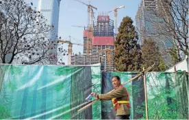  ??  ?? BEIJING: A constructi­on worker walks outside a building site in Beijing yesterday. Prices for goods at the factory gate in China beat expectatio­ns slightly in February, rising for the sixth straight month as strong demand boosts the world’s...