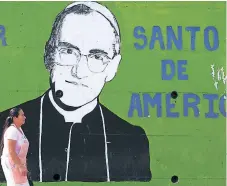  ?? AFP ?? INFLUENCIA. Una salvadoreñ­a captada en una de las calles de San Salvador, donde es común la imagen de Romero.