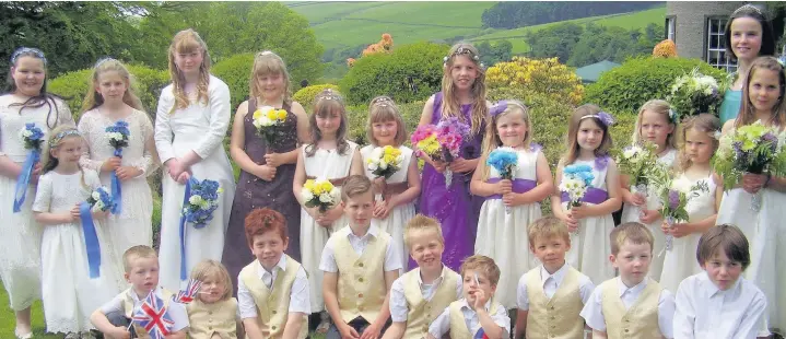  ??  ?? ●● The royals and their attendants gather for the annual Wildboarcl­ough Rose Queen Fete in the spectacula­r setting of Crag Hall Gardens