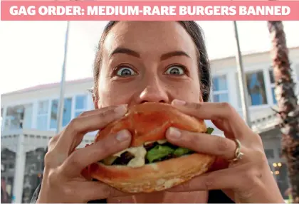  ?? BAYLEY MOOR / FAIRFAX NZ ?? Restaurant manager Kelsey Benefield tucks in to the popular medium-rare Governor’s Burger at the Duke of Marlboroug­h in Russell.