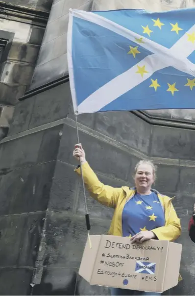  ??  ?? 0 Remain supporters outside the Court of Session, Edinburgh, where judges have delayed ruling on a legal bid aimed at forcing Boris Johnson abide by the Benn Act and request a Brexit extension