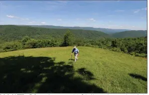  ?? (AP file photo) ?? Hydrologis­t William K. Jones walks up a mountain in Bolar, Va., near the proposed route for the Atlantic Coast natural gas pipeline in 2017. The pipeline’s developers announced Sunday that they are canceling the project.