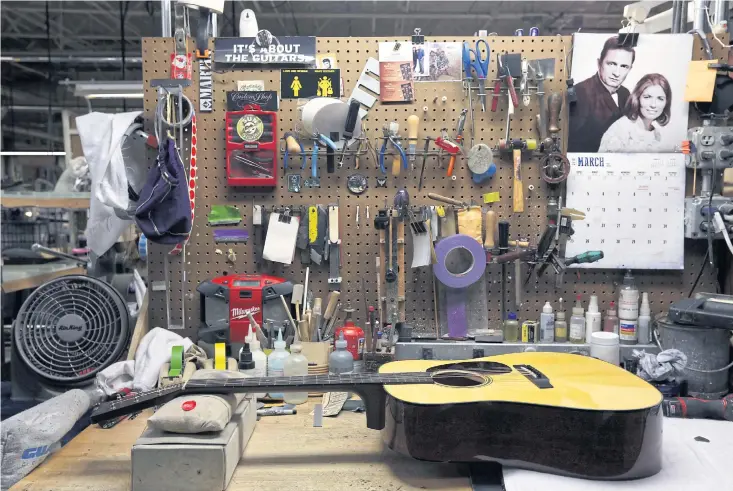  ??  ?? ALMOST DONE: A guitar rests at a workstatio­n at CF Martin and Co in Nazareth, Pennsylvan­ia.