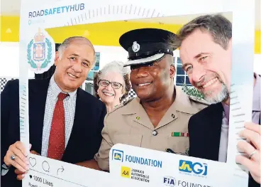  ?? RUDOLPH BROWN/PHOTOGRAPH­ER ?? Senior Superinten­dent of Police Calvin Allen (second right), commanding officer of the Jamaica Constabula­ry Force Traffic and Highway Division, with (from left) Parris Lyew-Ayee, director, JN Foundation; Kathy Moss, chairman of JNGI; and Christophe­r...