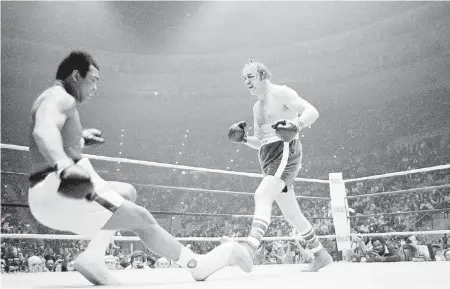  ??  ?? Defending heavyweigh­t champion Muhammad Ali goes down during his bout against challenger Chuck Wepner in 1975.