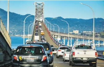  ?? John Storey / Special to The Chronicle ?? Above: The Richmond-San Rafael Bridge is jammed at rush hour. Left: A mock-up of a high-speed train sits outside the state Capitol.