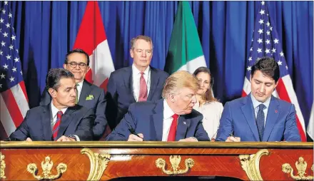  ?? AP PHOTO ?? President Donald Trump, Canada’s Prime Minister Justin Trudeau, right, and Mexico’s President Enrique Pena Nieto, left, participat­e in the USMCA signing ceremony, Friday, in Buenos Aires, Argentina.