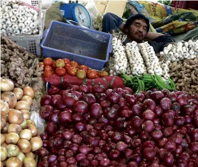  ?? PHOTO BY EV ESPIRITU/ INQUIRER NORTHERN LUZON ?? POWERNAP VEGETABLE sales appear to have been brisk, allowing this trader to get a power nap before engaging in another transactio­n.