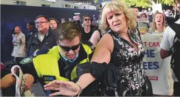  ?? AFP ?? Protesters jostle at a Liberal Party fund-raiser in Sydney, yesterday, as they call on the government to bring back refugees from an Australian detention centre in Papua New Guinea.