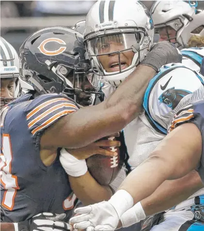  ?? | AP ?? Linebacker Leonard Floyd wraps up Panthers quarterbac­k Cam Newton in the first half. The Bears sacked Newton five times.