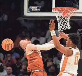  ?? BOB DONNAN/USA TODAY SPORTS ?? Texas guard Chendall Weaver and Tennessee forward Tobe Awaka battle during Saturday night's NCAA Tournament game.