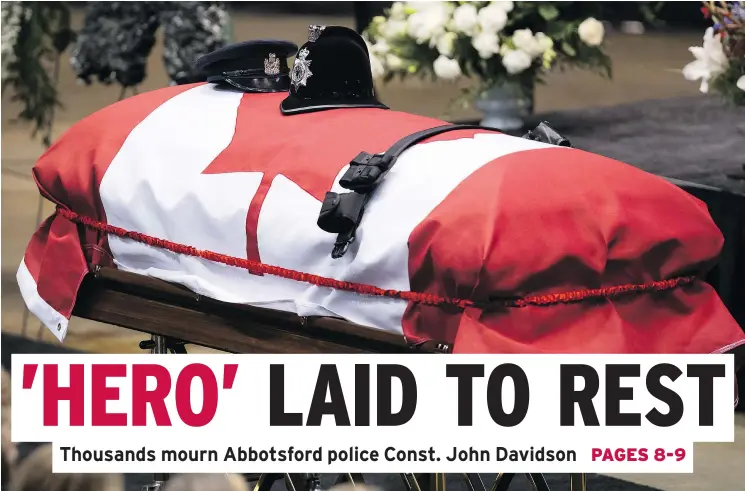  ?? — CP ?? Police hats belonging to Abbotsford Const. John Davidson, including one from when he was an officer in the U.K., rest on his casket during a service in Abbotsford Sunday.