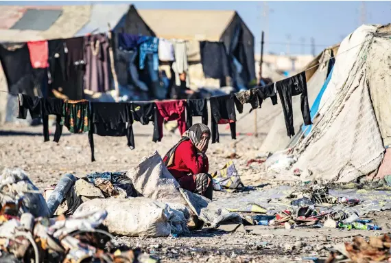  ?? AFP/File ?? Main: A woman sits outside a tent at a camp for those displaced by conflict in the countrysid­e near Syria’s northern city of Raqqa.