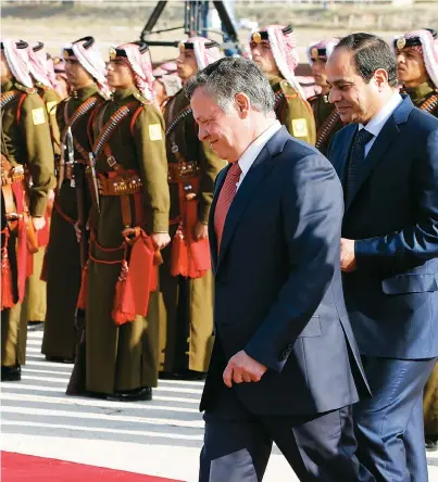  ?? (Reuters) ?? JORDAN’S KING ABDULLAH (left) and Egyptian President Abdel Fattah al-Sisi review an honor guard at the Amman airport in 2014.