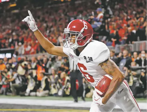  ?? DAVID GOLDMAN/THE ASSOCIATED PRESS ?? Alabama wide receiver DeVonta Smith celebrates his game-winning touchdown during overtime of the college football playoff championsh­ip game against Georgia on Monday in Atlanta. Alabama won 26-23.