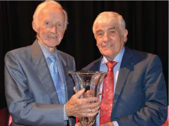  ??  ?? Seamus McCormack being presented with his award by Paddy Kelly.