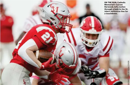  ?? ?? ON THE RUN: Catholic Memorial’s Carson Harwood, left, rushes through a hole in the St. John’s defensive line for a touchdown.