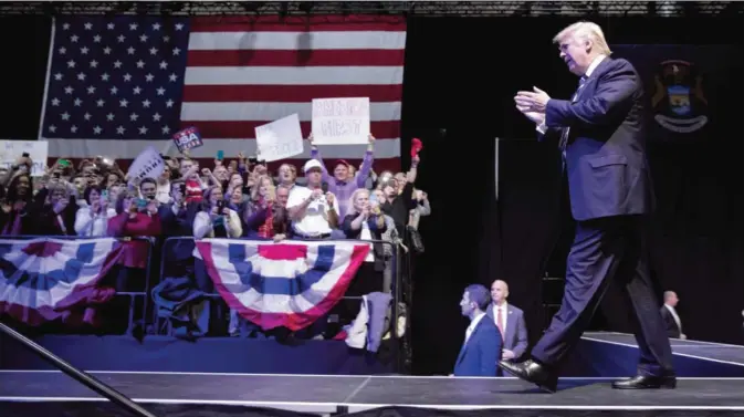  ?? — AFP ?? GRAND RAPIDS: President-elect Donald Trump waves to the crowd as he arrives onstage at the DeltaPlex Arena.