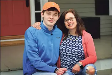  ?? Erik Trautmann / Hearst Connecticu­t Media ?? Luke Schwartz, 16, and his mom, Deborah List at their home Thursday in Wilton. Schwartz has a rare type of thyroid cancer and a host of other health issues and had hoped that, due to his health issues, he’d get the COVID vaccine early. But, when Lamont went by an age classifica­tion, His mother took matters into her own hands and got Luke vaccinated in Vermont, where the family also owns a home.
