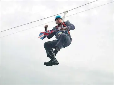  ?? Rebecca Denton Getty Images ?? THEN-LONDON Mayor Boris Johnson is left dangling from a zip line over Victoria Park after a 2012 publicity stunt for the Olympic Games went awry. The politician seems absolutely immune to embarrassm­ent.