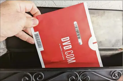  ?? Associated Press photos ?? A Netflix DVD envelope is shown on Nov. 17 in San Francisco. Subscriber­s to Netflix’s DVD-by-mail service still look forward to opening up their mailbox and finding one of the discs delivered in the familiar red-and-white envelopes.