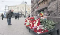  ?? REUTERS ?? A man pays his respects at a makeshift memorial to the victims of a shooting attack at the Crocus City Hall in Moscow, in Saint Petersburg on Sunday.