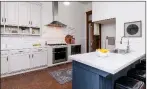  ??  ?? The updated kitchen offers stainless-steel appliances and subway-tile backsplash­es.