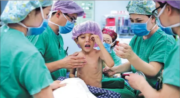  ?? WANG JING / CHINA DAILY ?? A child with congenital heart disease from Afghanista­n is prepared for an operation at the First Affiliated Hospital of Xinjiang Medical University in northweste­rn China on Saturday. The program is part of the Red Cross Society of China’s humanitari­an...