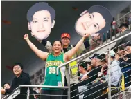  ?? Photo: Reuters* ?? Fans hold up cut-outs of hometown hero Zhou Guanyu during the sprint qualifying at the Chinese Grand Prix in Shanghai.