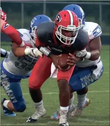  ?? LARRY GREESON / For the Calhoun Times ?? Sonoravill­e’s Patrick Moore (center) tries to break the tackle of two Cass defenders in the first half on Friday.